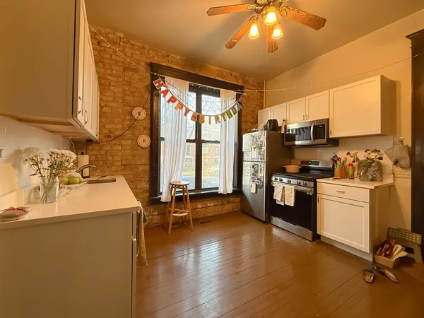 a view of a kitchen with workspace and windows