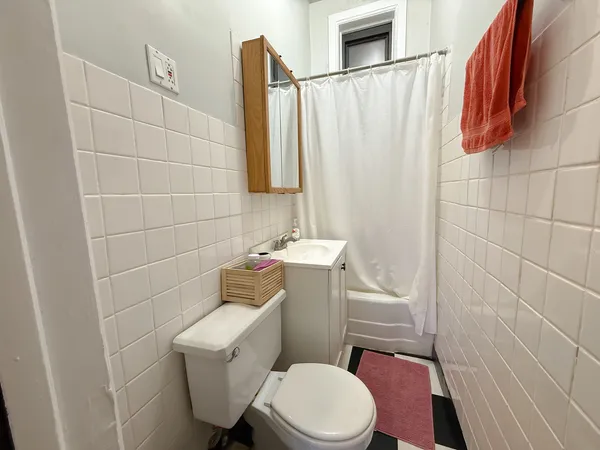 a white toilet sitting next to a bathroom sink