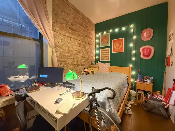 a bed sitting in a bathroom next to a mirror