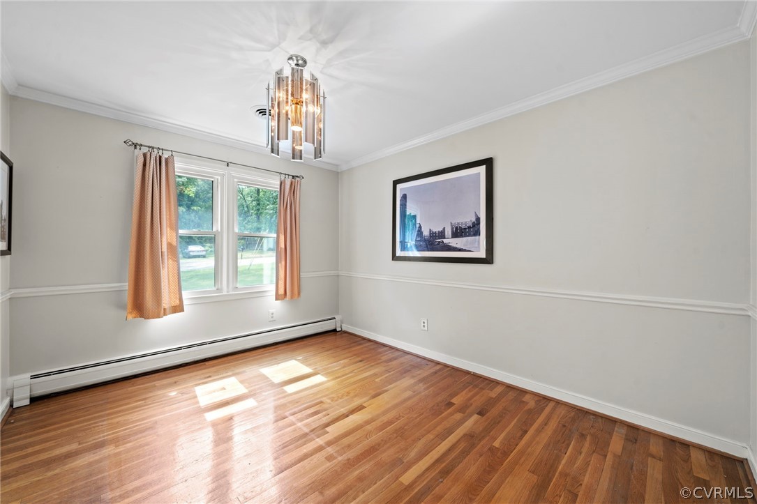 4001 Croatan Road Richmond, VA 23235 - Photo 5 of 25 a view of an empty room with wooden floor and a window