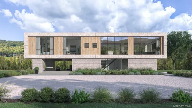 a front view of a house with a yard and potted plants