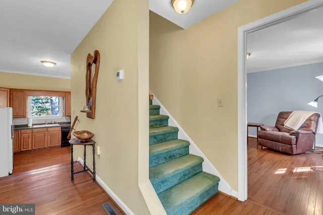 a kitchen with stainless steel appliances granite countertop wooden floors sink and cabinets
