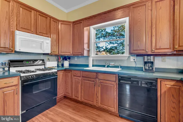 a kitchen with a stove top oven and refrigerator