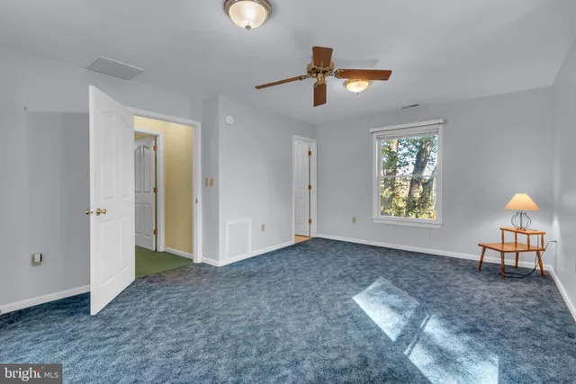 a bedroom with bed and a chandelier