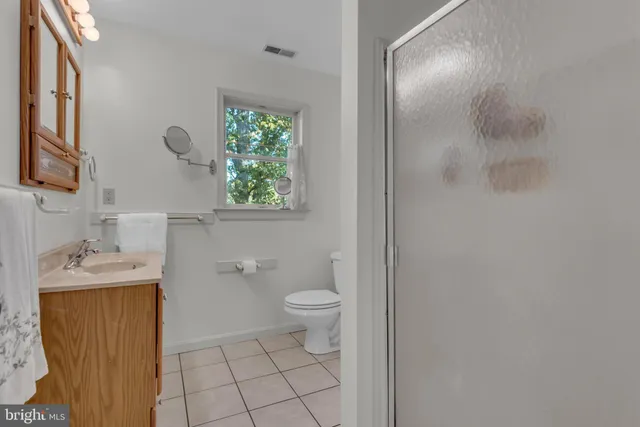 an empty room with windows and ceiling fan view