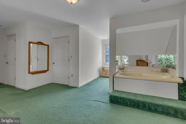 an empty room with a ceiling fan and a window