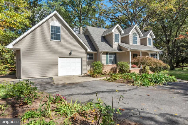 a front view of a house with a yard and a garage