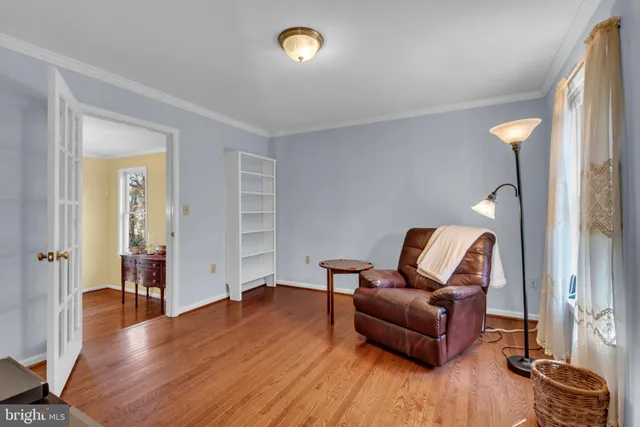 a living room with furniture flat screen tv and wooden floor