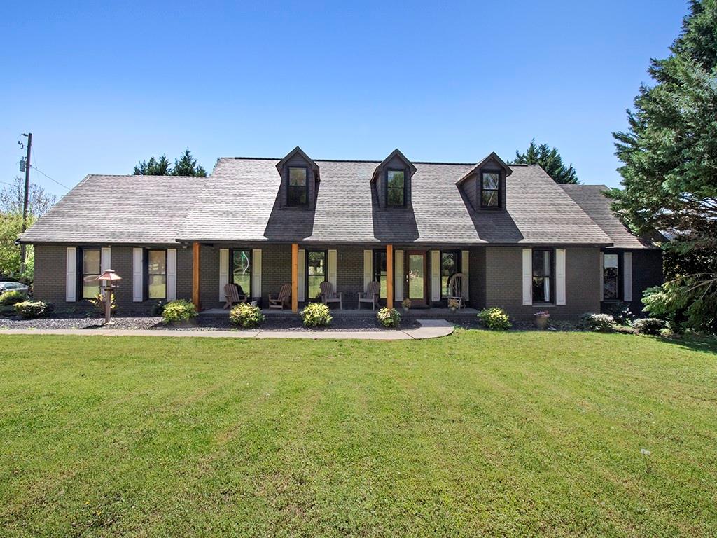 3919 Evans Road Cumming, GA 30040 - Photo 1 of 1 a front view of a house with yard patio and swimming pool