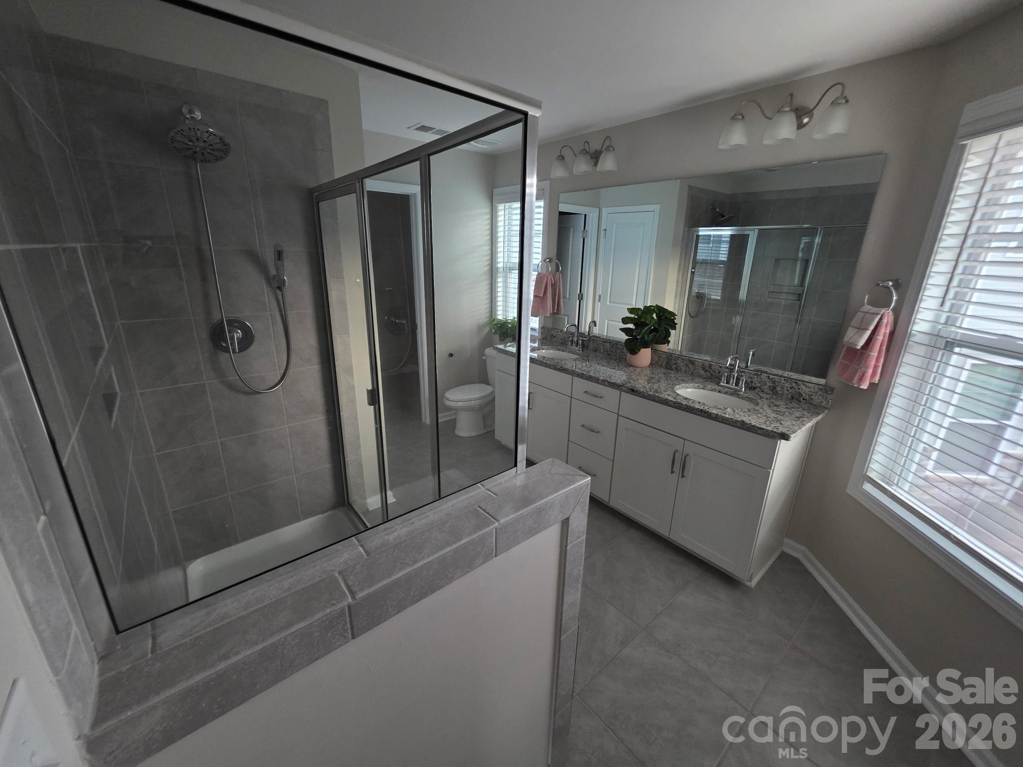 592 Altamonte Drive Clover, SC 29710 - Photo 12 of 22 a bathroom with a granite countertop sink mirror and shower