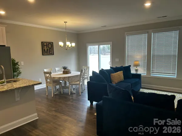 a living room with furniture a dining table and a piano table