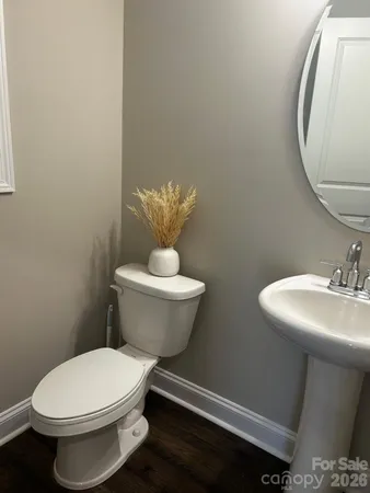 a white toilet sitting next to a bathroom sink