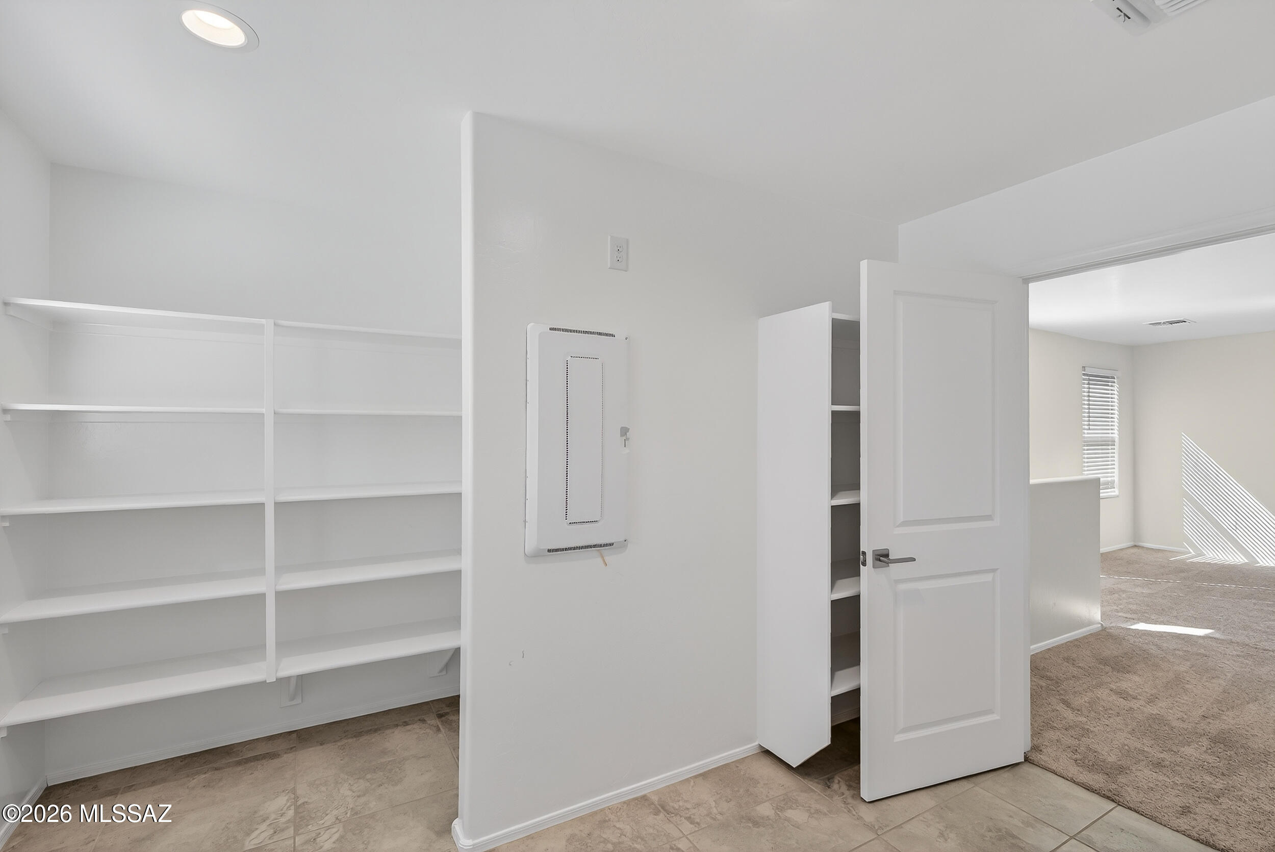 7556 South Circulo Rio Blanco Tucson, AZ 85756 - Photo 29 of 50 Tall open shelving, and plenty of room to work. This a highly functional space right where you need it most, near all the bedrooms.