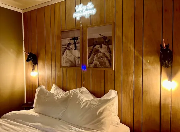 a bed room with a bed and a mirror