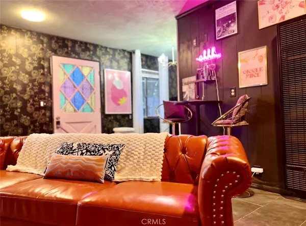 a bedroom with furniture and painting on the wall