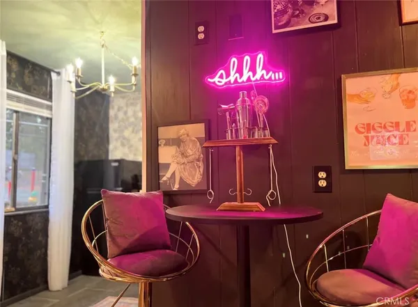 a view of a room with furniture and chandelier
