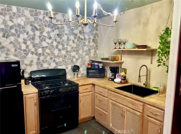 a kitchen with stainless steel appliances a stove a sink and a refrigerator