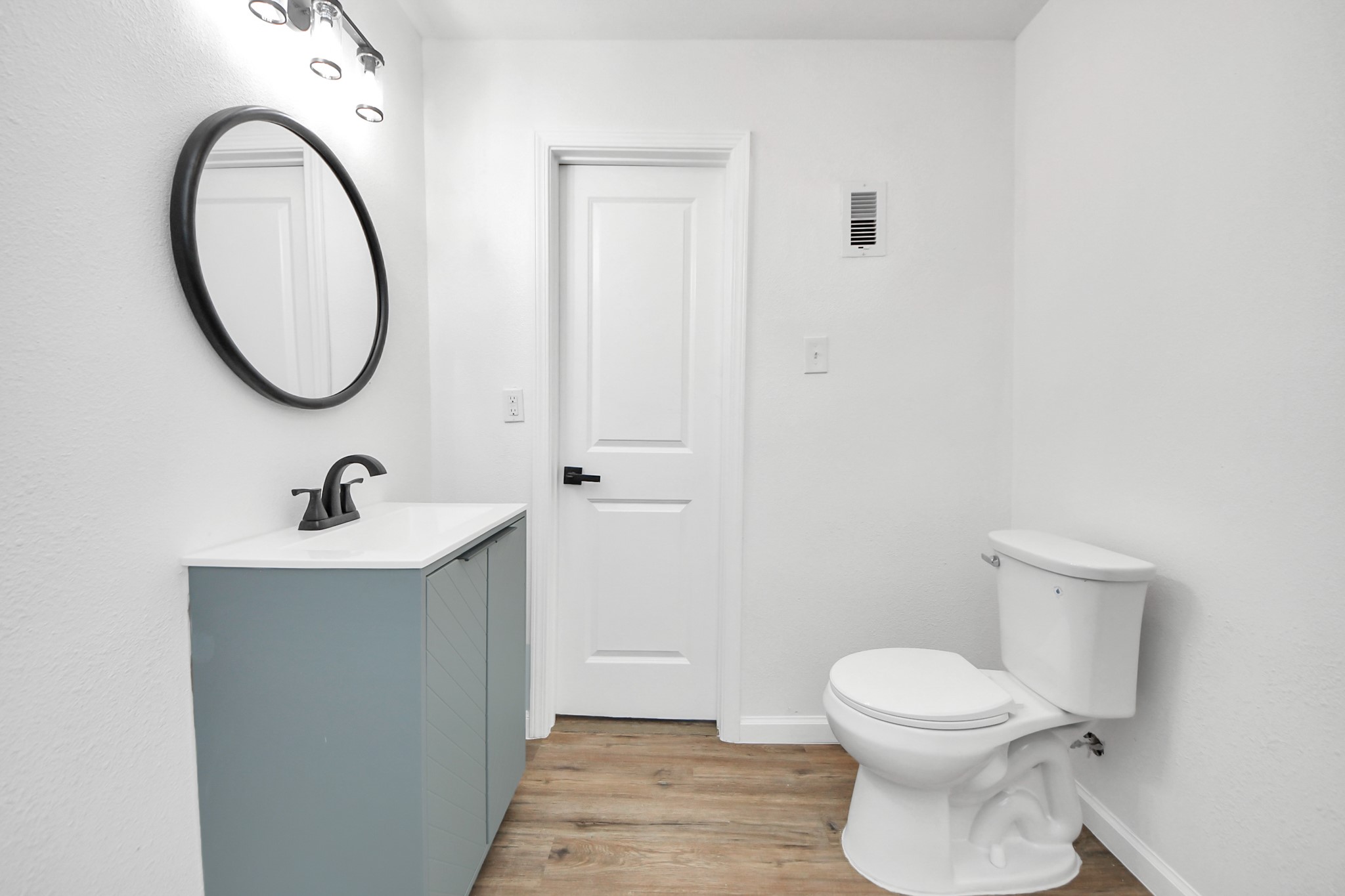 207 East Defee Avenue Baytown, TX 77520 - Photo 24 of 36 a bathroom with a sink a toilet and a mirror
