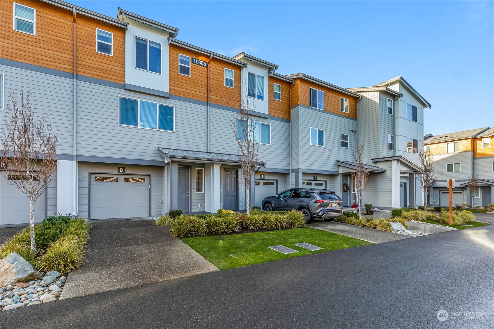 a front view of a building with cars parked