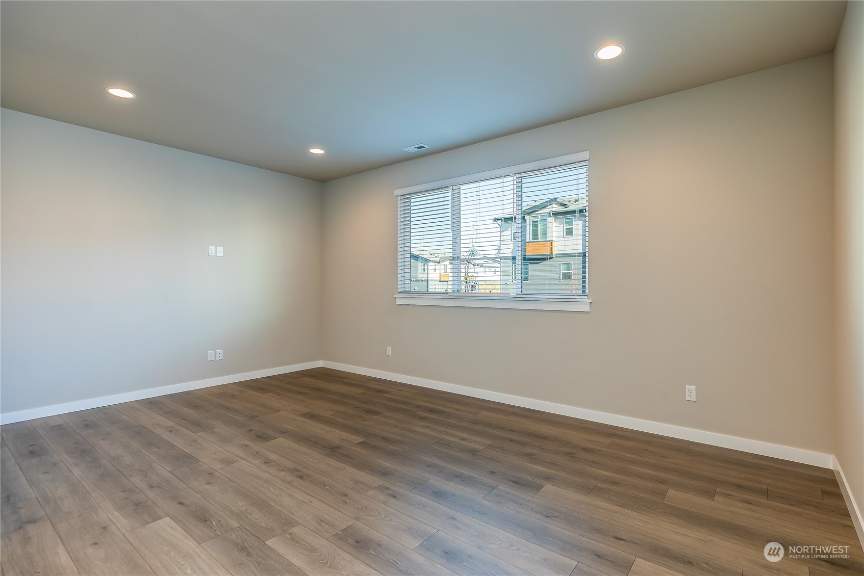 19308 35th Drive Southeast, Unit D Bothell, WA 98012 - Photo 11 of 32 an empty room with wooden floor and windows