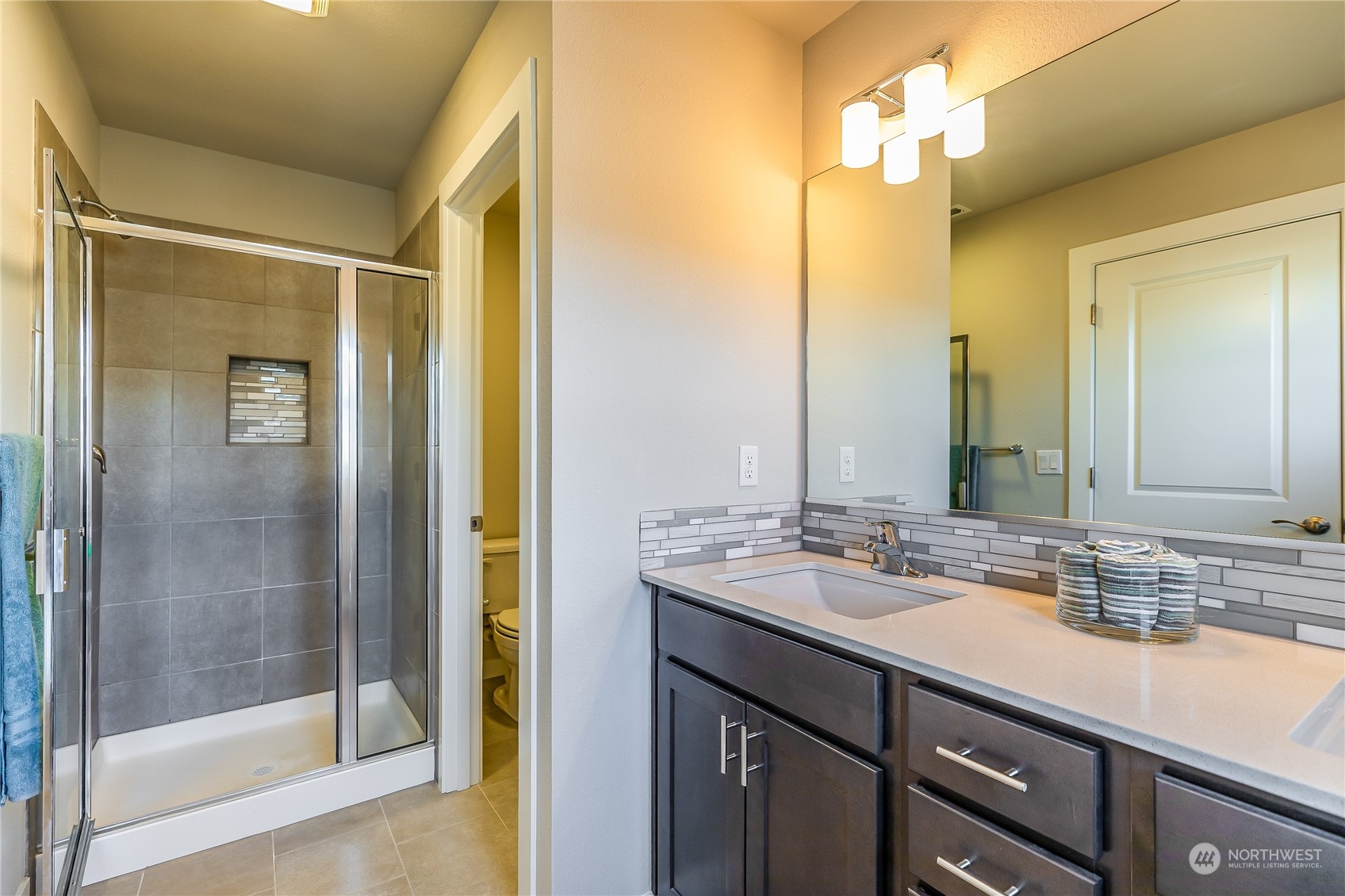 19308 35th Drive Southeast, Unit D Bothell, WA 98012 - Photo 18 of 32 a bathroom with a double vanity sink and a mirror