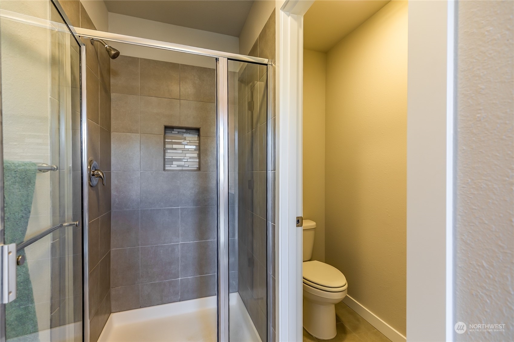 19308 35th Drive Southeast, Unit D Bothell, WA 98012 - Photo 19 of 32 a bathroom with a granite countertop toilet and a shower