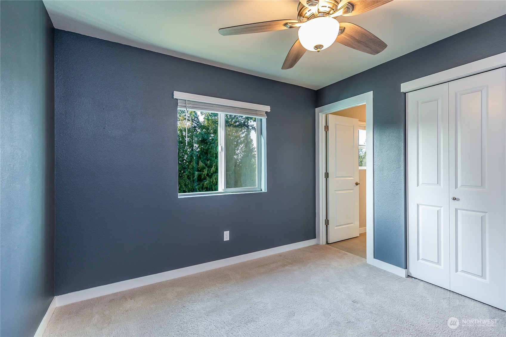 19308 35th Drive Southeast, Unit D Bothell, WA 98012 - Photo 23 of 32 an empty room with a ceiling fan and a window