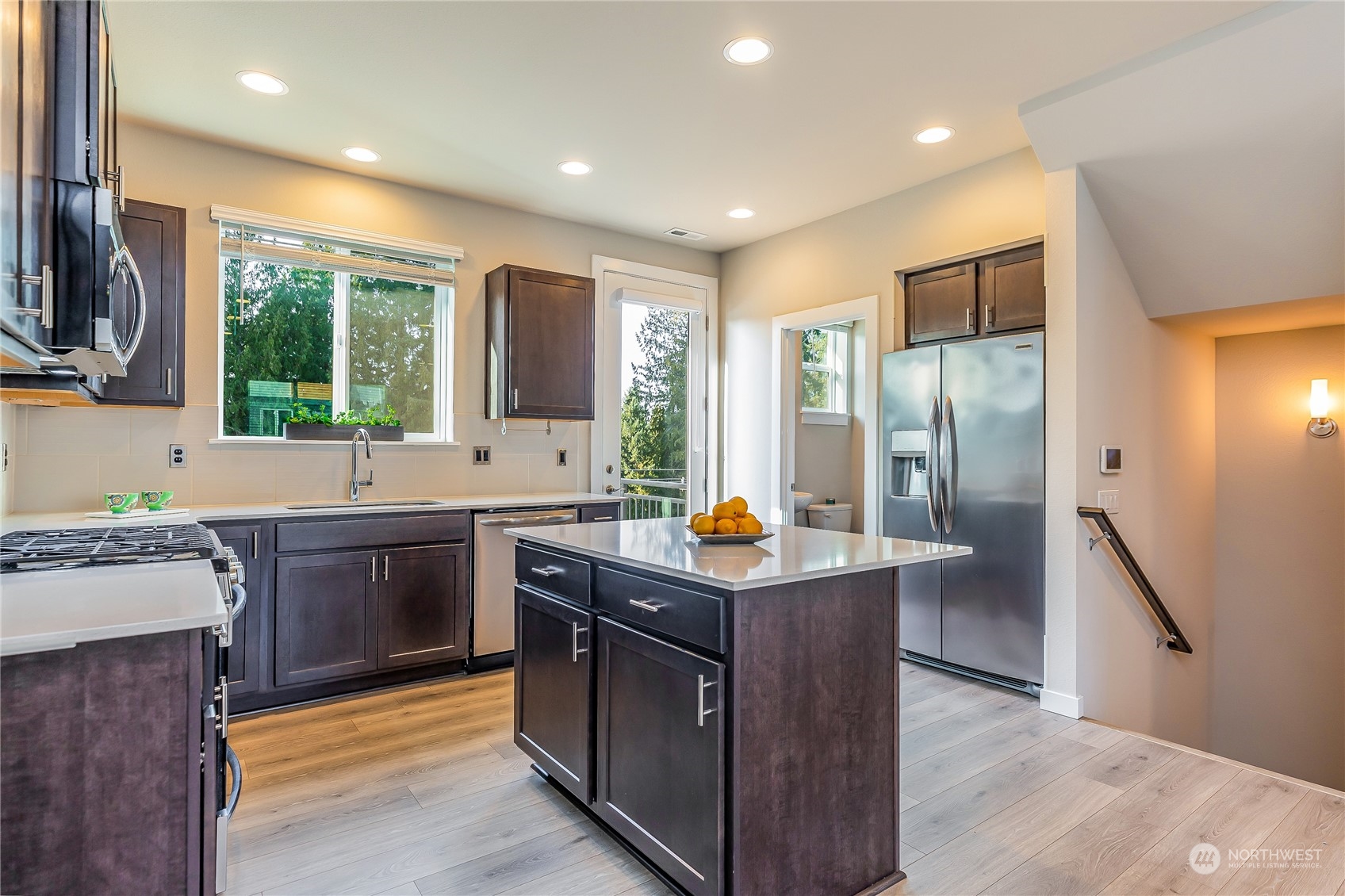 19308 35th Drive Southeast, Unit D Bothell, WA 98012 - Photo 4 of 32 a kitchen with stainless steel appliances granite countertop a sink stove and refrigerator