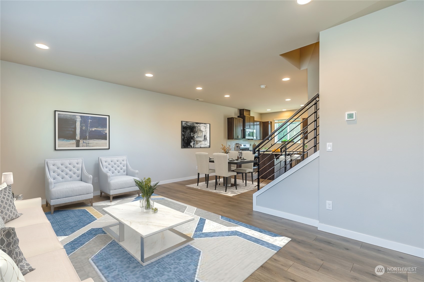 19308 35th Drive Southeast, Unit D Bothell, WA 98012 - Photo 8 of 32 a living room with couches and a dining table with wooden floor