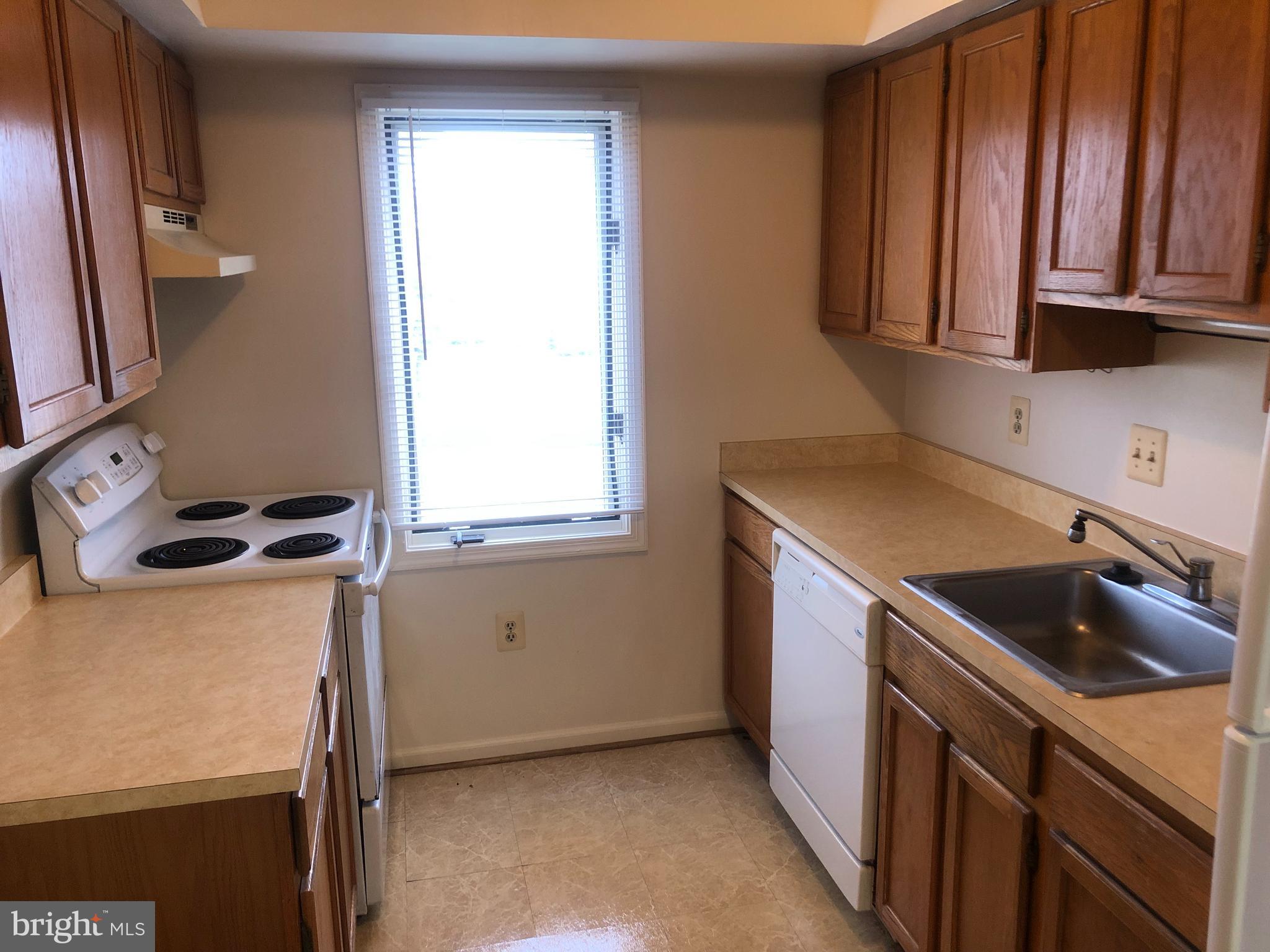 2 James Street, Unit 1B Frederick, MD 21701 - Photo 5 of 11 a kitchen with a refrigerator stove and a sink