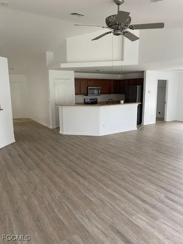 a view of a room with wooden floor