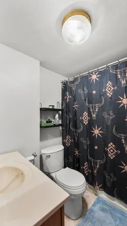 a bathroom with a toilet sink and shower