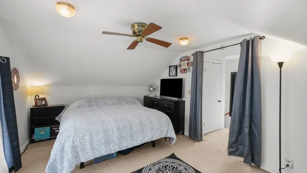 a bedroom with a bed and a flat tv screen