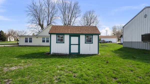 a view of a house with yard and a tree