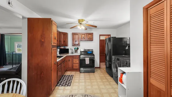 a kitchen with stainless steel appliances granite countertop a refrigerator and a stove top oven