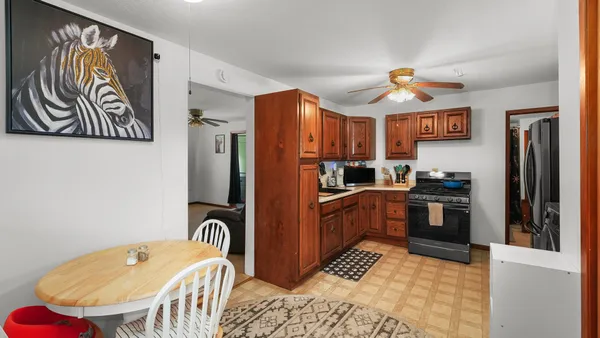 a kitchen with stainless steel appliances granite countertop a refrigerator and a stove top oven