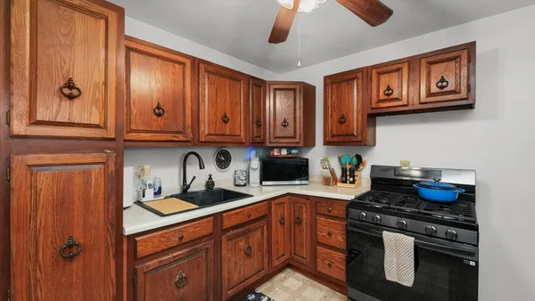 a kitchen with stainless steel appliances granite countertop a stove and cabinets
