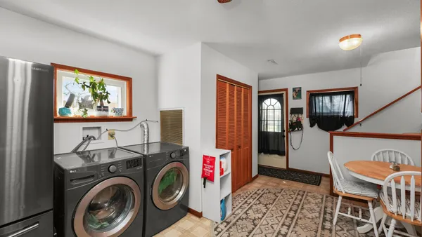 a view of a bedroom with washer and dryer