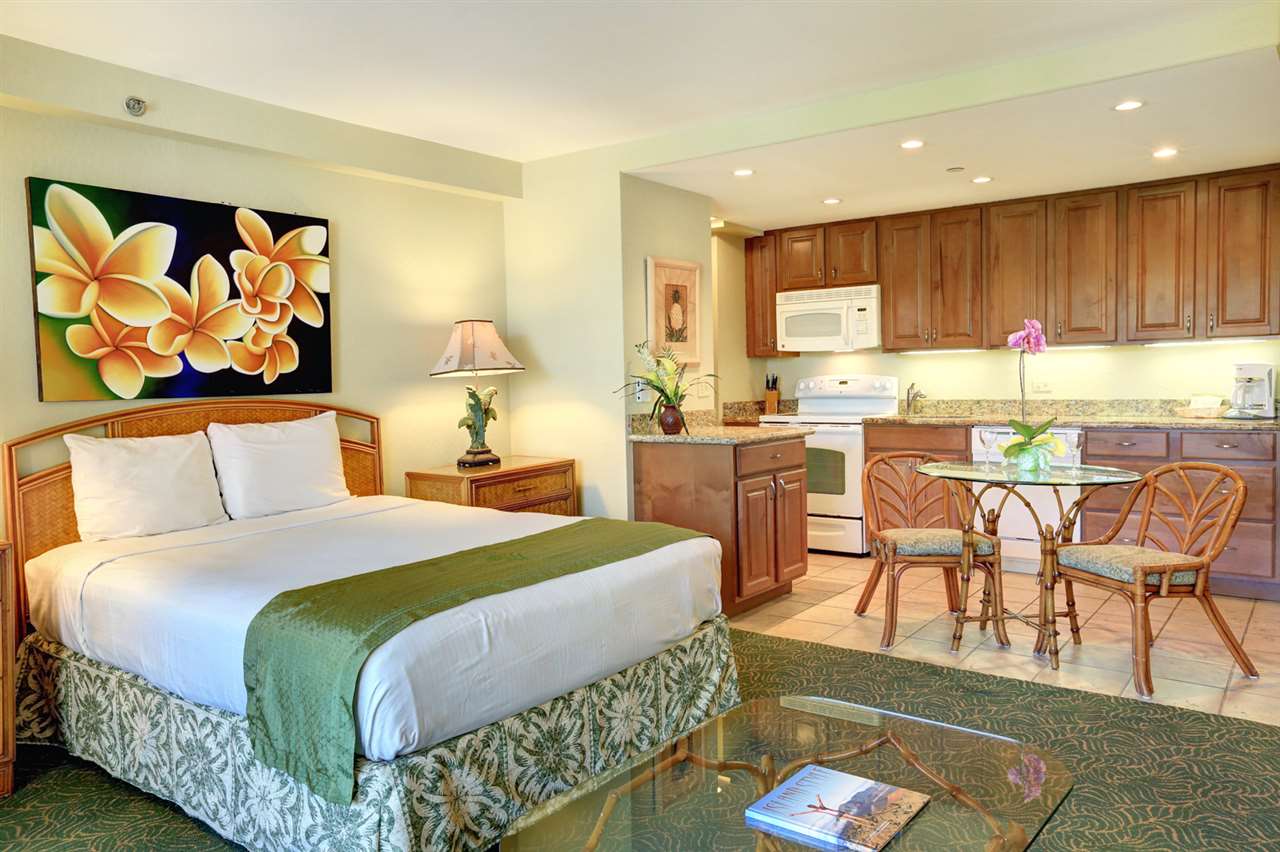3445 Lower Honoapiilani Road, Unit 336 Lahaina, HI 96761 - Photo 12 of 22 a spacious bedroom with a bed a table and chairs