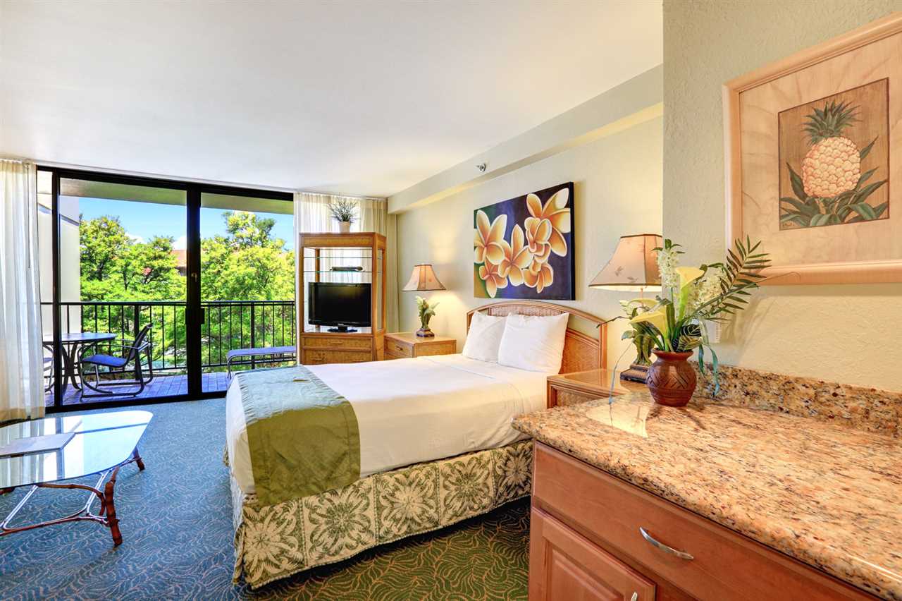 3445 Lower Honoapiilani Road, Unit 336 Lahaina, HI 96761 - Photo 13 of 22 a bedroom with a bed and glass windows