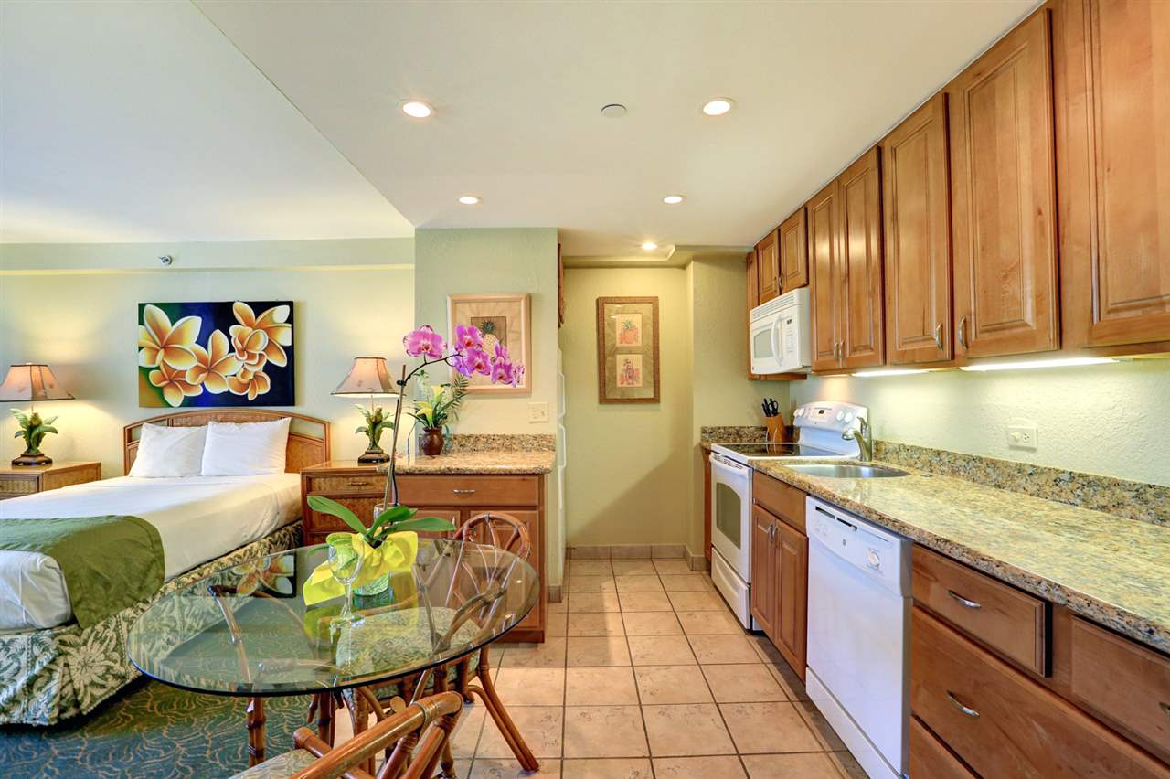 3445 Lower Honoapiilani Road, Unit 336 Lahaina, HI 96761 - Photo 10 of 22 a kitchen with stainless steel appliances kitchen island granite countertop a sink and cabinets