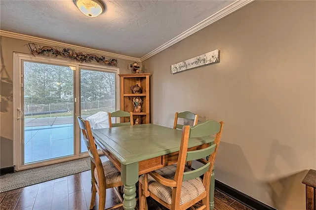 a view of a dining room with furniture and a window