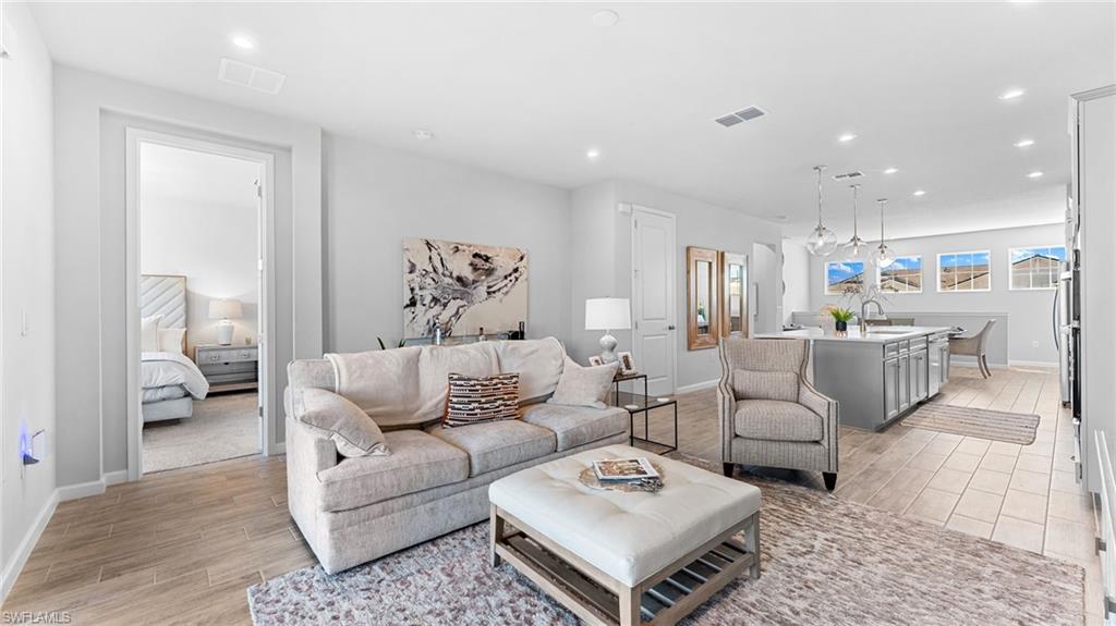 4601 Arboretum Circle, Unit 202 Naples, FL 34112 - Photo 15 of 37 a living room with furniture and view of kitchen
