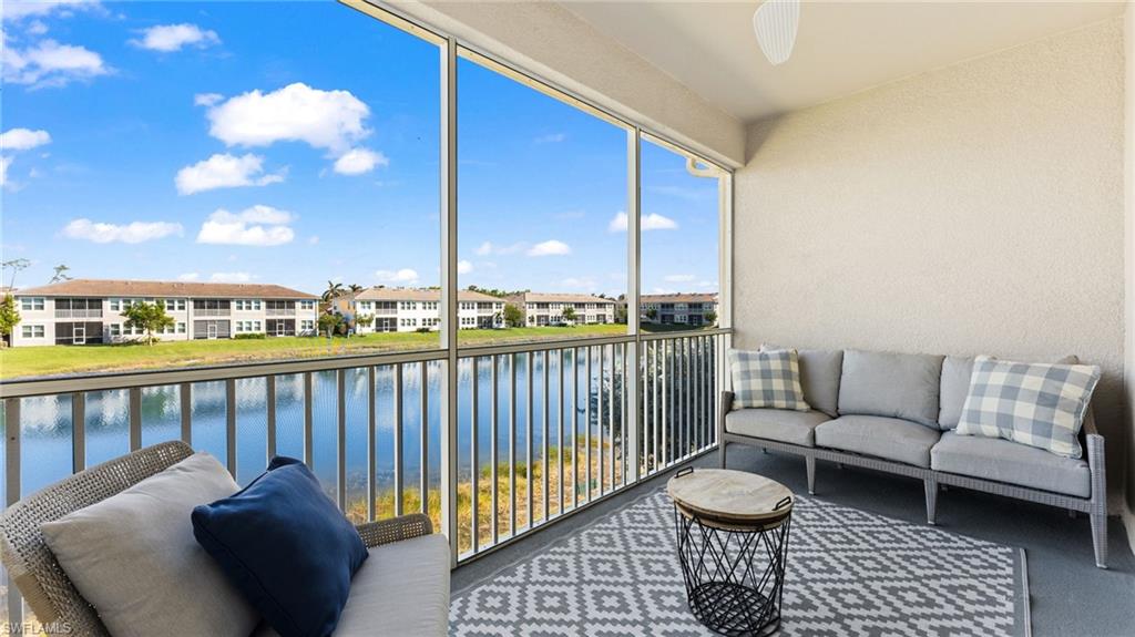 4601 Arboretum Circle, Unit 202 Naples, FL 34112 - Photo 20 of 37 a living room with furniture and a floor to ceiling window
