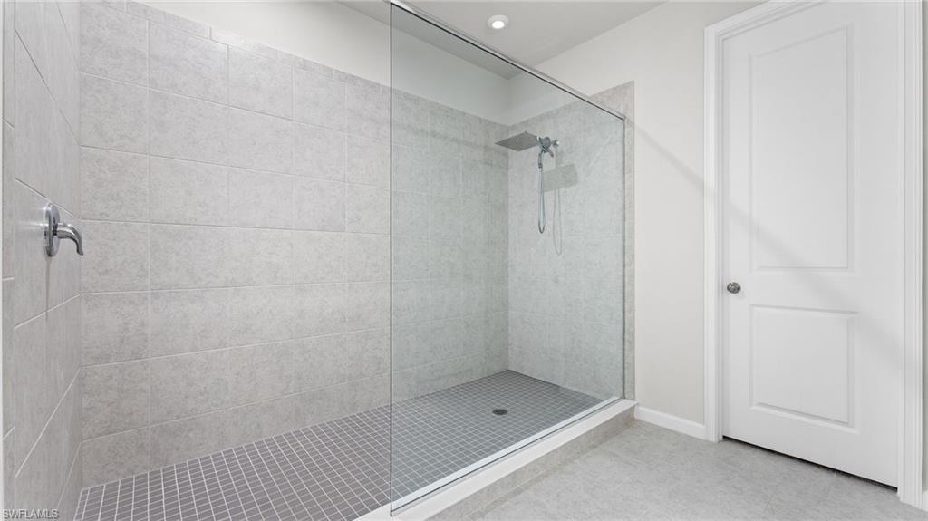 4601 Arboretum Circle, Unit 202 Naples, FL 34112 - Photo 25 of 37 a bathroom with a glass shower door