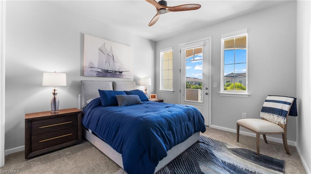 4601 Arboretum Circle, Unit 202 Naples, FL 34112 - Photo 26 of 37 a bedroom with a bed and a lamp on table