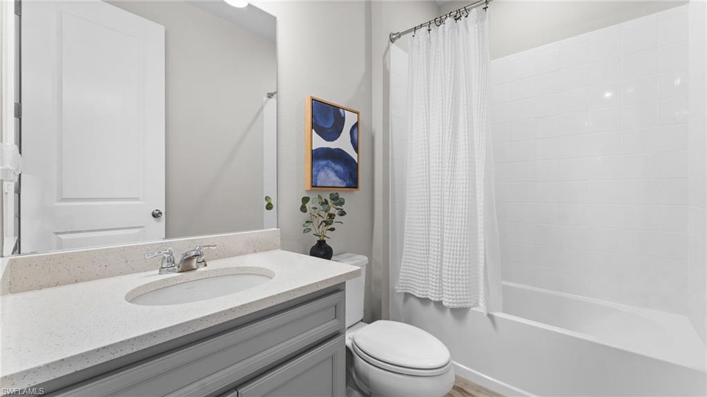 4601 Arboretum Circle, Unit 202 Naples, FL 34112 - Photo 29 of 37 a bathroom with a sink toilet and shower