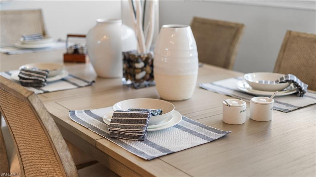 4601 Arboretum Circle, Unit 202 Naples, FL 34112 - Photo 5 of 37 a living room with chairs and a table