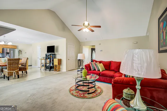 a living room with furniture and kitchen view
