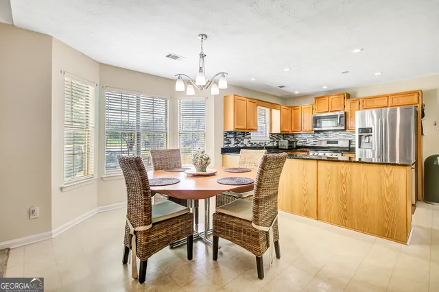 a view of a dining room with furniture and a window